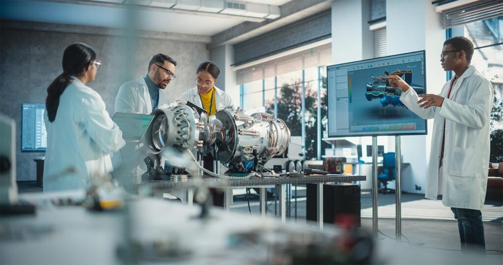 Researchers talking in a manufacturing facility