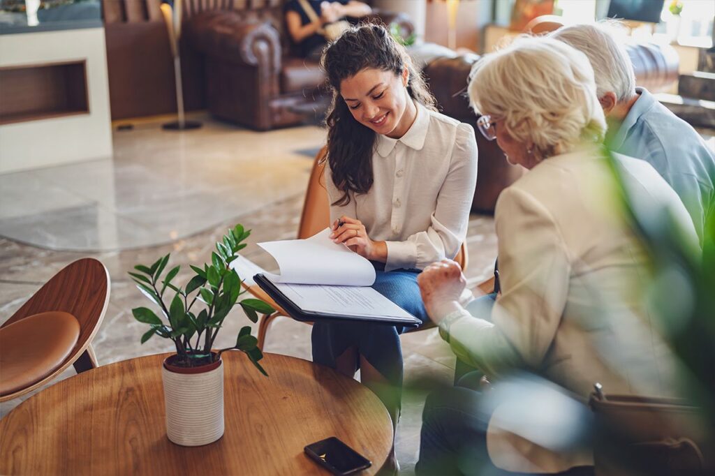 Woman speaking with a senior couple